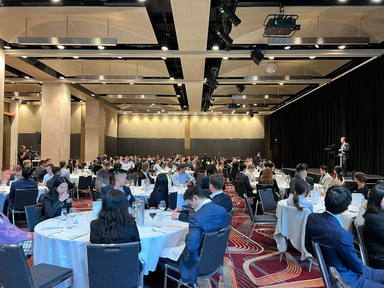 Guests seated at round tables during a conference luncheon